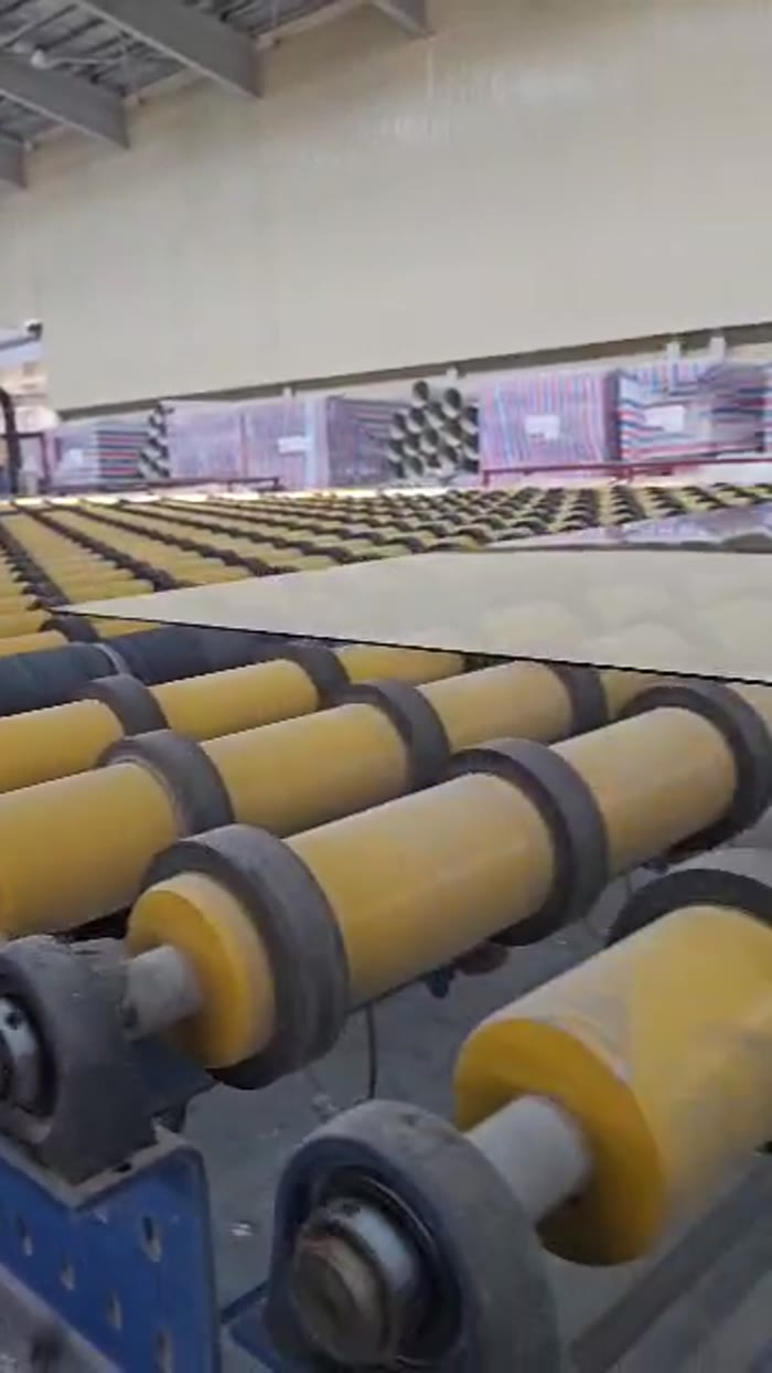 Detail of glass conveyor rollers in a SIG production line